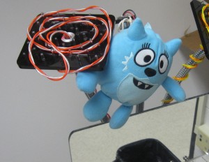 Figure 1b: A close up of the mirror (bottom right), electroluminescent wires (top left), and shaking toy (center).