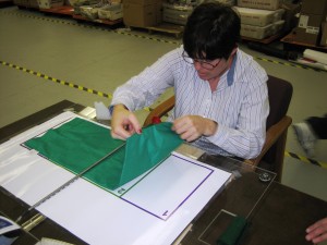 Figure 2a: Client folding a pillowcase over the center-divide rod. 