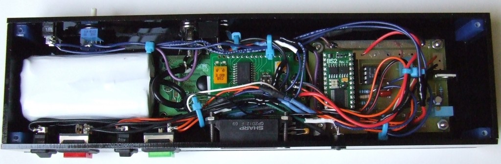 Figure 2 - Interior of the device, which shows the battery, the back side of the LCD module, and the PCB (printed circuit board) mounted inside the device’s enclosure. Control switches are also visible on the sides of the device.