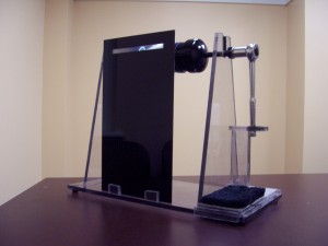 Figure 2: The Comfort reader device. The acrylic screen with a Fresnel lens is in the front, and the ratcheting mechanism is on the right side. The client pushes forward on the padded area on the base to push the ratchet handle and advance the text by 1 line.