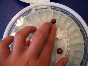Figure 2: The user is loading pills into every 4th compartment (corresponding to Sunday morning, Monday morning, etc.) using the Pill Loader trays.