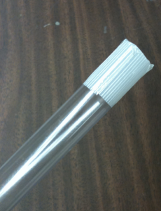 Figure 1b: The plastic channel tube with two pieces of filament tape properly placed over one end