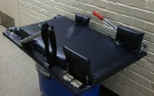Figure 1: The Final Stretch device.  In this view, the head would rest on the left and the torso to the right, and the winch lever arm is positioned for left handed operation to crank the right arm back.