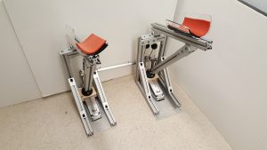 The floating pedal system consists of two levers. When the user presses down on a lever with his forearms, the lever action presses down on the pedals, striking the bass drum