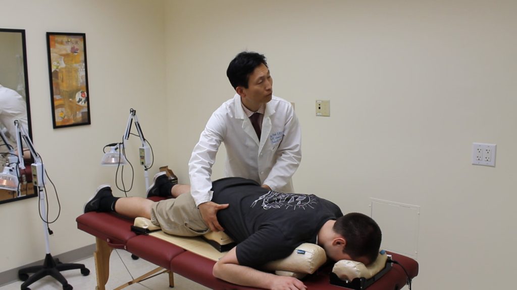 Dr. Park treating a client in the pelvic balancer.