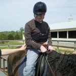 Figure 2: The client wearing the hip belt and preparing to ride in the outdoor arena.